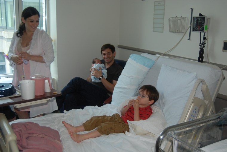 Author Lauren Brody after the birth of her son Teddy, with her older son Will enjoying her hospital bed.