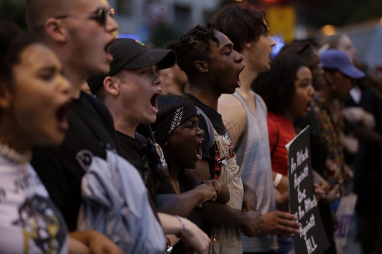 Image: Demonstrators chant as they protest in Chicago