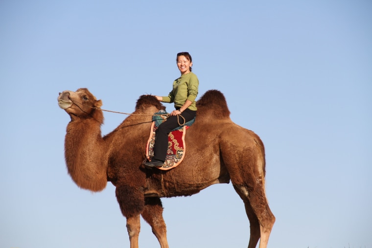 Chimgee Haltarhuu of Mission Manduhai riding a camel in Mongolia.