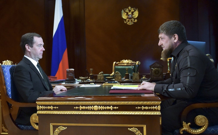 Image: A newspaper says police in Chechnya, ruled by Ramzan Kadyrov (right) have rounded up more than 100 suspected gay men