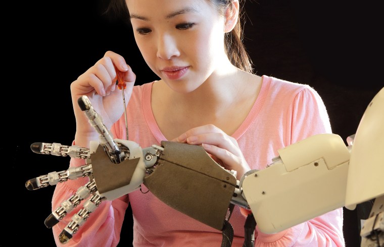 woman working on robot hand