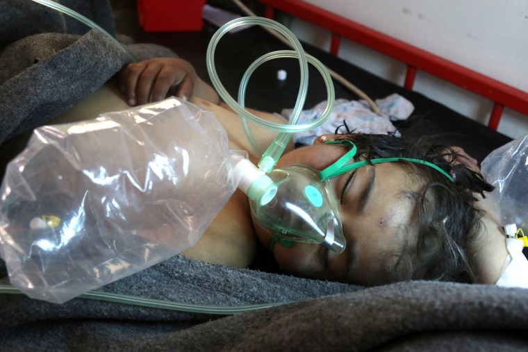 Image: A Syrian child receives treatment at a small hospital in the town of Maaret al-Noman following a suspected toxic gas attack