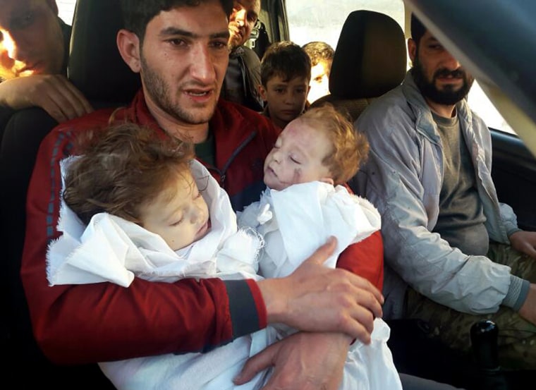 Image: Abdul-Hamid Alyousef holds his twin babies who were killed during a suspected chemical weapons attack in Syria