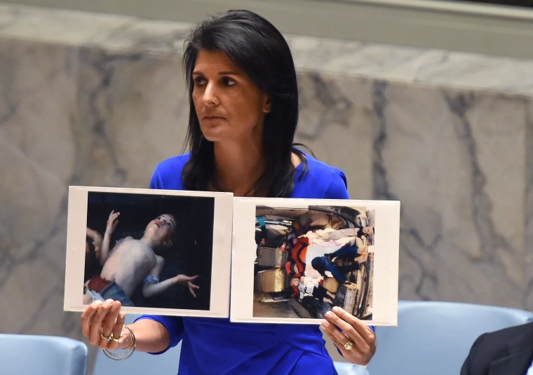 Image: Nikki Haley held photos of victims as she spoke at an U.N session on the suspected gas attack.