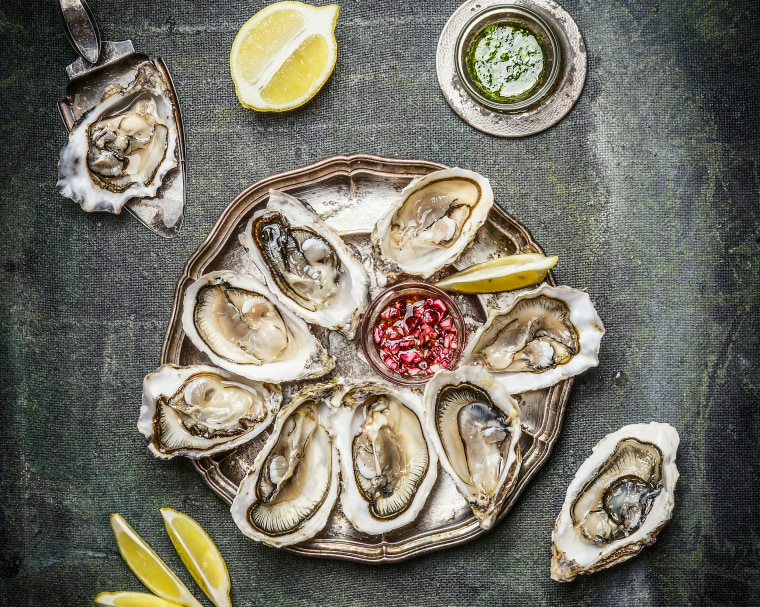 Oysters plate with lemon and sauces , top view