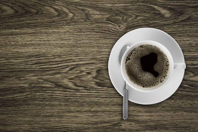 Coffeecup with Coffee in it on a wooden table