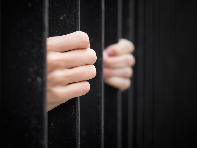 Prisoner behind jail bars