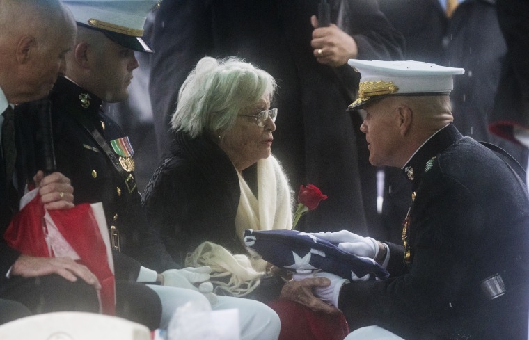 Image: Annie Glenn receives a flag at the funeral for husband John Glenn