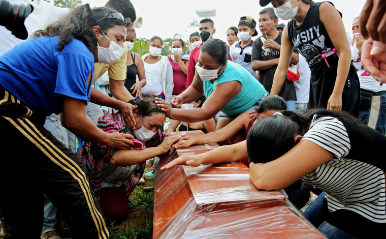 Image: People mourn loved ones at a mass funeral after a mudslide hit Mocoa