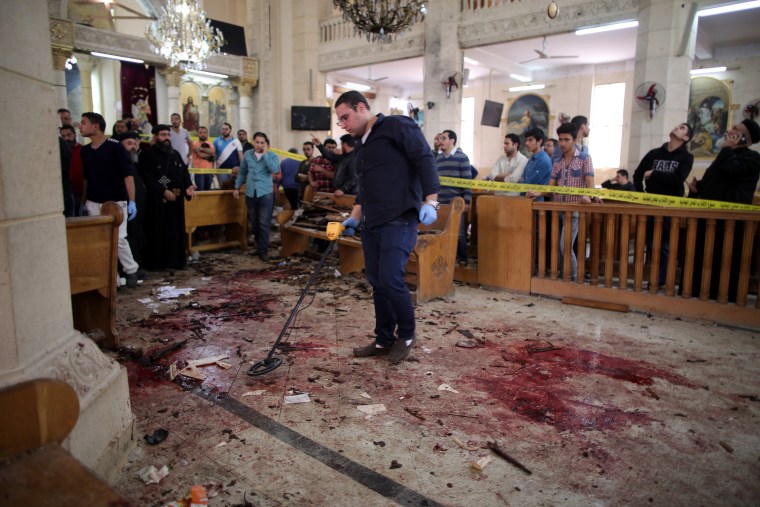 Image: Security personnel investigate the scene of a bomb blast inside a church