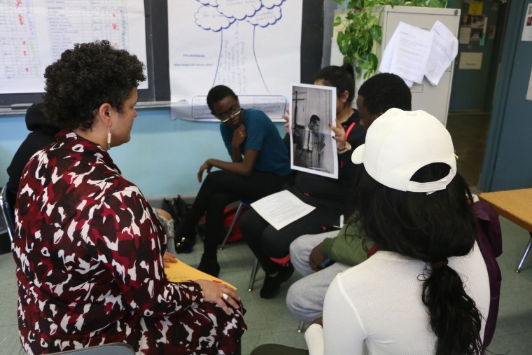 Teaching artist Signe V. Harriday leads students through an exercise at the Manhattan International High School.