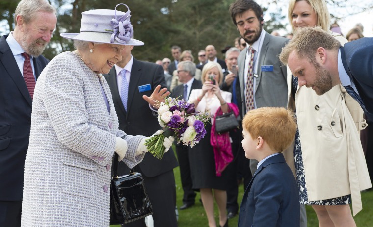 Queen Elizabeth II accepts a bouquet of flowers