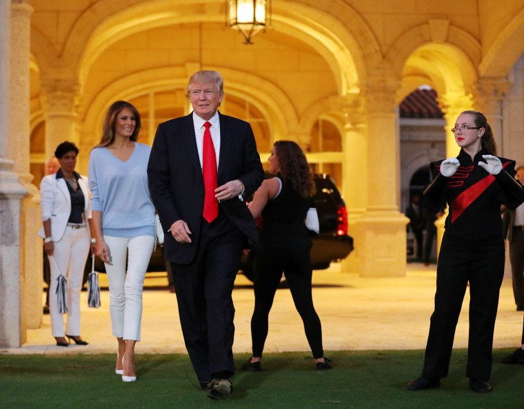 Image: Trump and First Lady Melania Trump greet a marching band as they arrive at Trump International Golf club to watch the Super Bowl LI between New England Patriots and Atlanta Falcons in West Palm Beach, Florida, U.S.