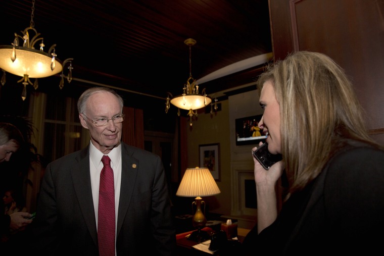 Image: Republican Gov. Robert Bentley listens to a phone call as Rebekah Mason, right, announces his win for Alabama governor, in Montgomery, Alabama, Nov. 4, 2014.