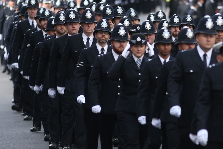 Image: London Police officers march along the funeral route of PC Keith Palmer