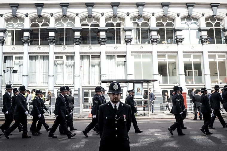 Image: Police officers march towards Southwark Cathedral for the funeral route of PC Keith Palmer