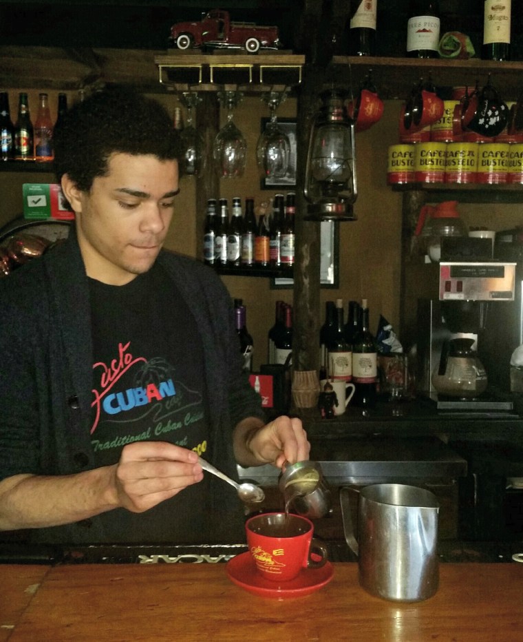 Duncan Spraling prepares cafe con leche at Gusto Cuban Cafe, in Ralston, Neb.