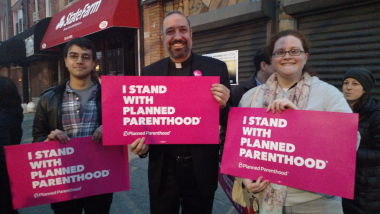 Abdullah Younus (l.) and Mary Hetteix join Rev. Khader El-Yateem. at a local demonstration to keep Planned Parenthood funded.