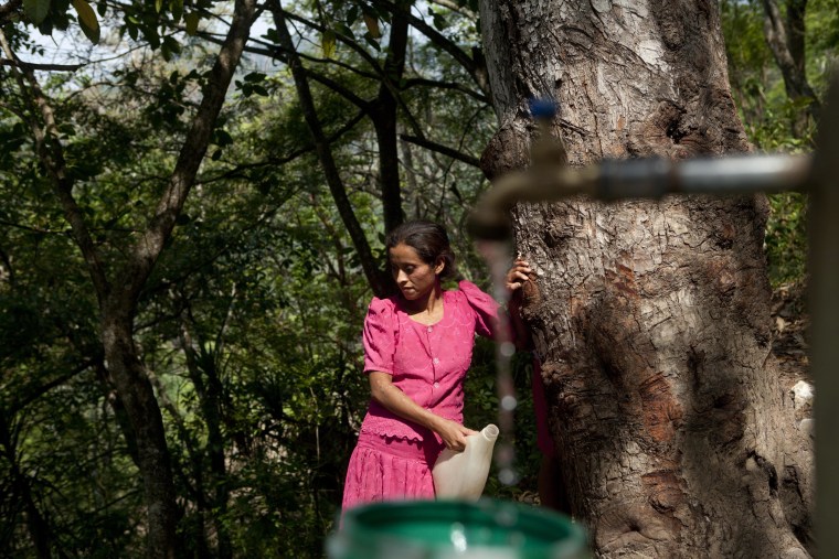 In this June 1, 2016 photo, a woman waits her turn to collect water in the village of Shalagua, in Guatemala's eastern state of Chiquimula.