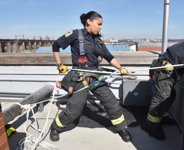 Firefighter Sarina Olmo of the FDNY's Engine 83 Ladder 29 in The Bronx, New York.