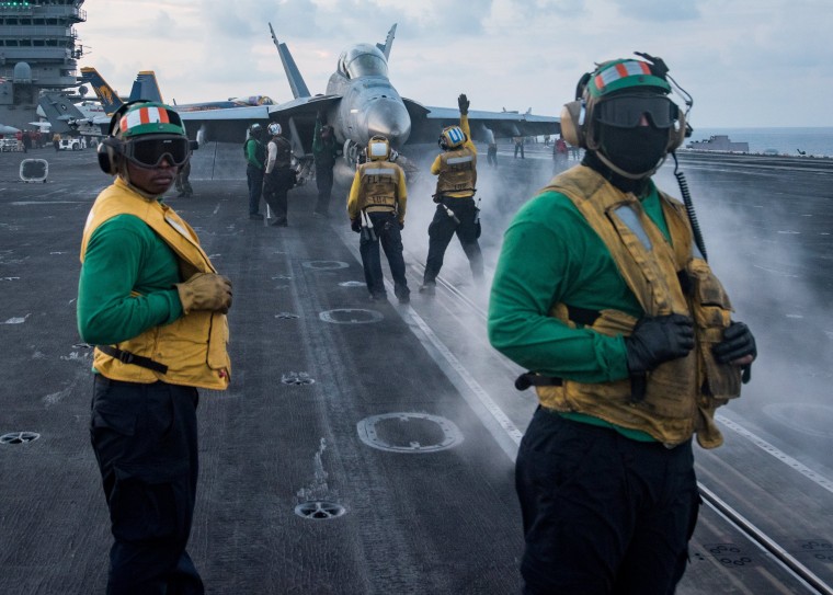 Image: Sailors conduct flight operations on the aircraft carrier USS Carl Vinson flight deck, in the South China Sea