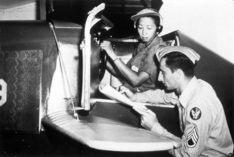 Hazel Lee reviewing her flight records in the cockpit.