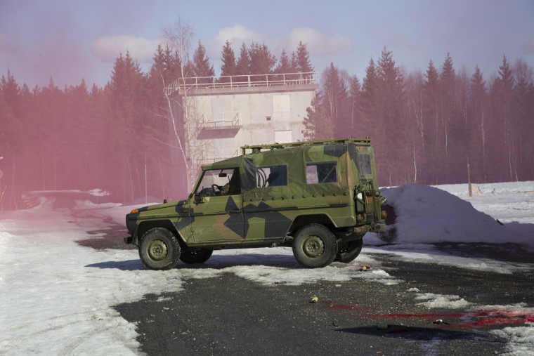 Image: An army vehicle arrives on the scene of an explosion with a back-up team of soldiers during a military training exercise at the Terningmoen Camp