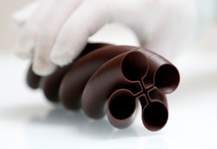 Image: Founder of the Miam Factory 3D printing chocolate company displays a three-dimensional shape object in Gembloux