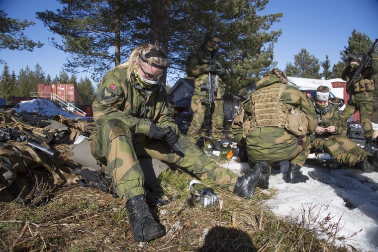 Image: Female soldiers reload their weapons during a break from their training at the Terningmoen Camp in Elverum