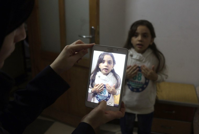 Image: Syrian Bana al-Abed is filmed by her mother as they prepare to post on Twitter in English about life in the besieged eastern districts of Syria's Aleppo, on October 12, 2016.