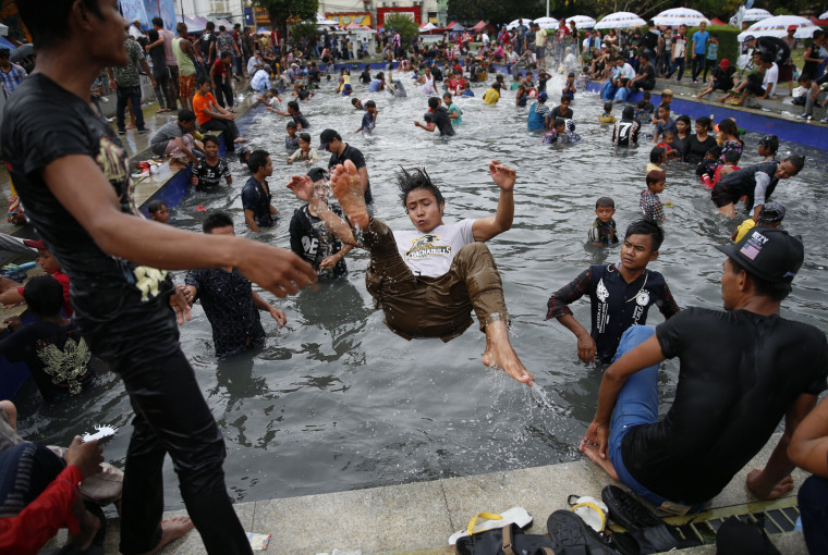 Image: Revelers swim in a pool during the Thingyan water festival in Yangon