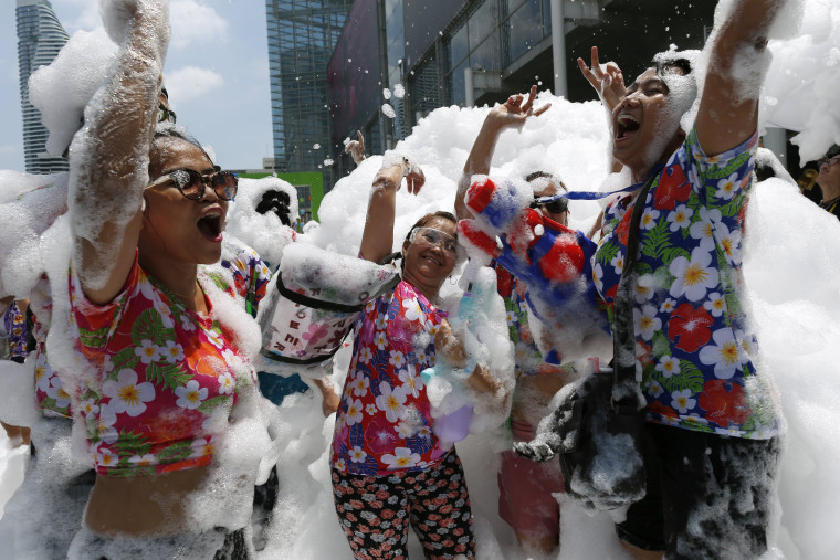 Image: Revelers dance in foam during the annual Songkran celebration in Bangkok