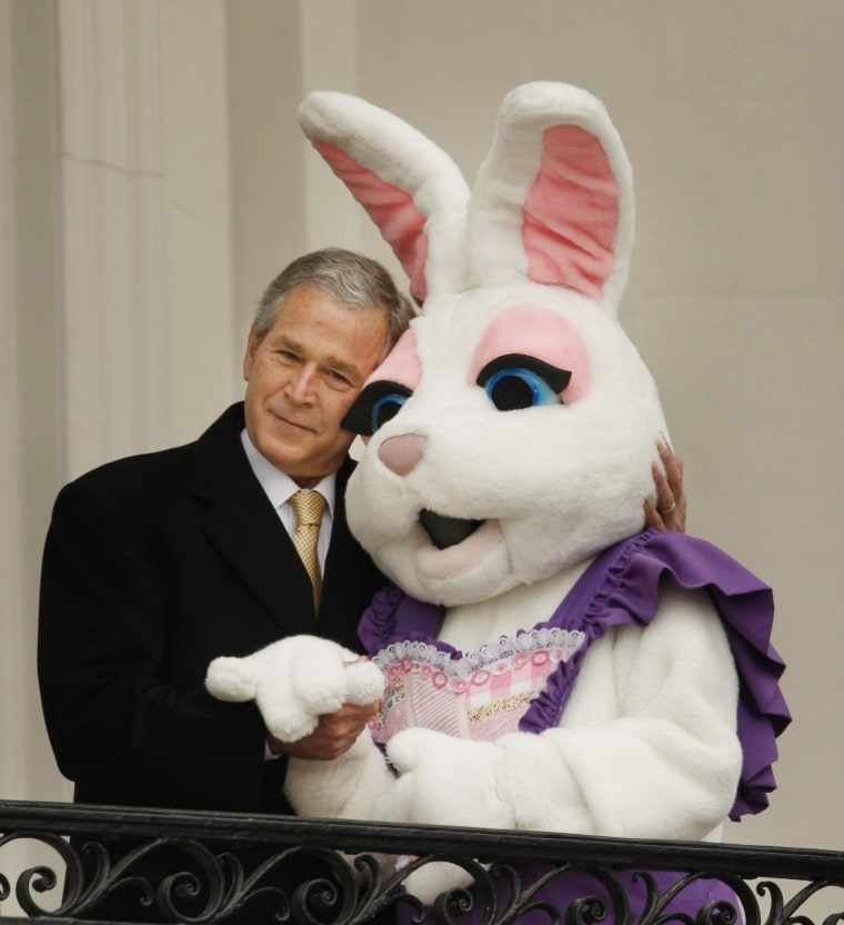 Image: President George W. Bush hugs a person dressed as the Easter bunny at the annual Easter egg roll