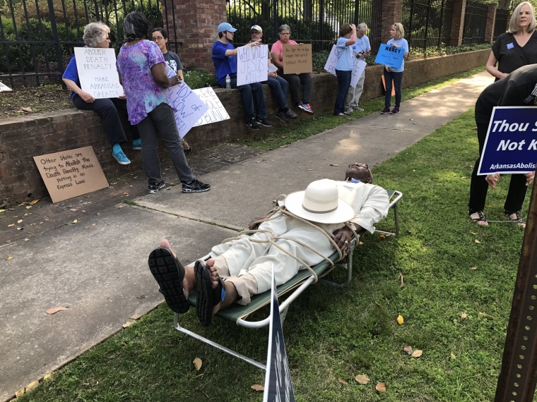 Image: Judge Wendell Griffen portrays a prisoner on a gurney during a protest against executions in front of the Governor's Mansion