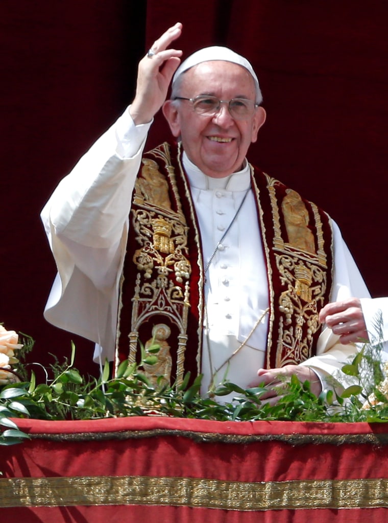 Image: Pope Francis waves during his Easter Sunday address.
