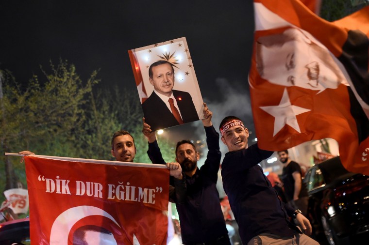 Image: Supporters of Turkish President Recep Tayyip Erdogan during a rally near the headquarters of the conservative Justice and Development Party (AKP) on April 16, 2017 in Istanbul, after the initial results of a nationwide referendum.