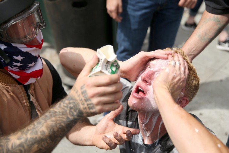 Image: A Trump supporter has milk poured in his eyes after being pepper sprayed by protesters in Berkeley.