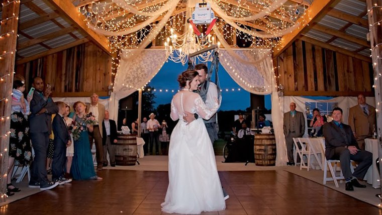 Paralyzed groom surprises wife for first dance.
