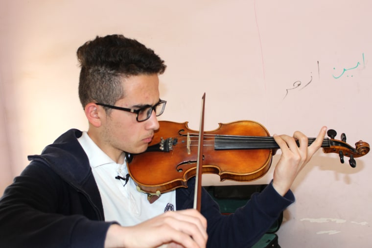 Image: Violinist Sherwan Mohammed Dhia, 17 learned English by listening to his idol, Eminem