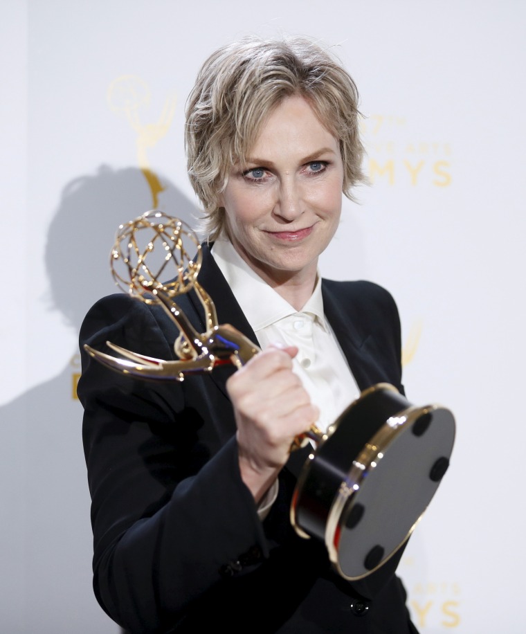 Image: Jane Lynch poses with her Emmy award for outstanding host for a reality or reality-competition