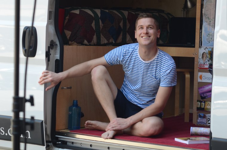 Mikah Meyer sitting in his van while road tripping.