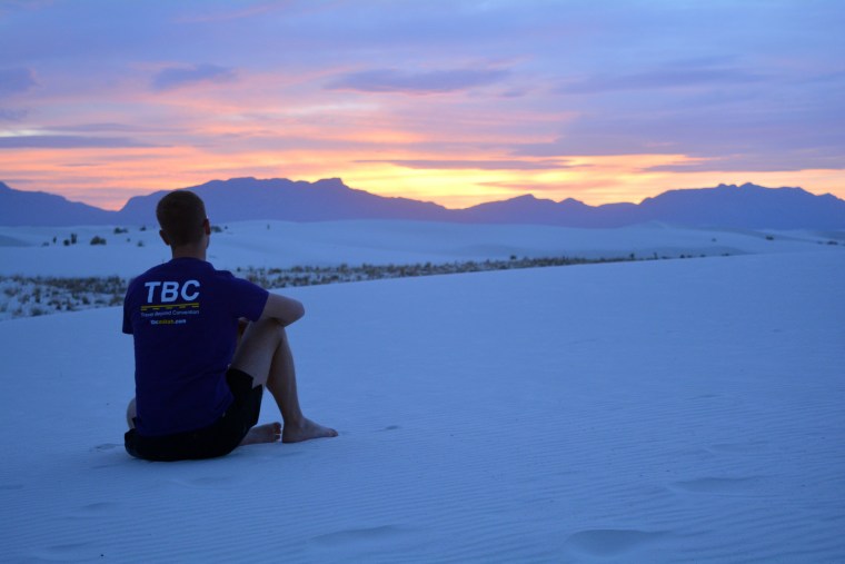 Mikah Meyer watching the sun set at White Sand National Monument in New Mexico