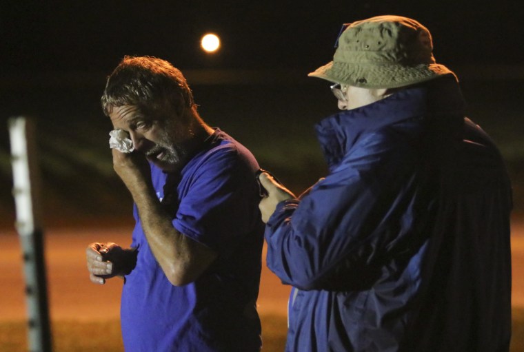 Image: Anti-death penalty supporter Randy Gardner, left, wipes away a tear moments after Abraham Bonowitz, left, reads on his phone the 11:45pm Supreme Court decision to halt the execution