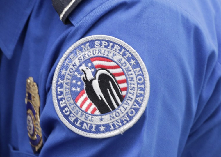 Image: A TSA shoulder patch is shown on the uniform of a Transportation  Security Administration officer