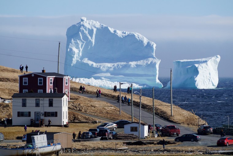 Image: Residents view the first iceberg of the season as it passes the South Shore of Newfoundland