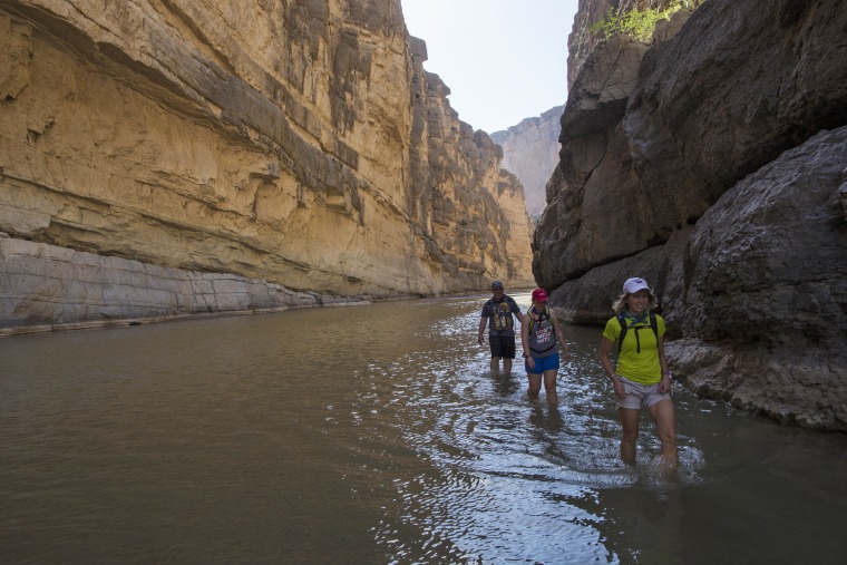 Image: Tourists walk in the water of the Rio Grande River in Big Bend National Park in Texas