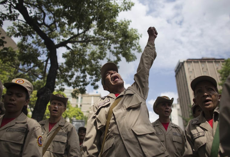 Image: A member of the Bolivarian Militia raises his fist