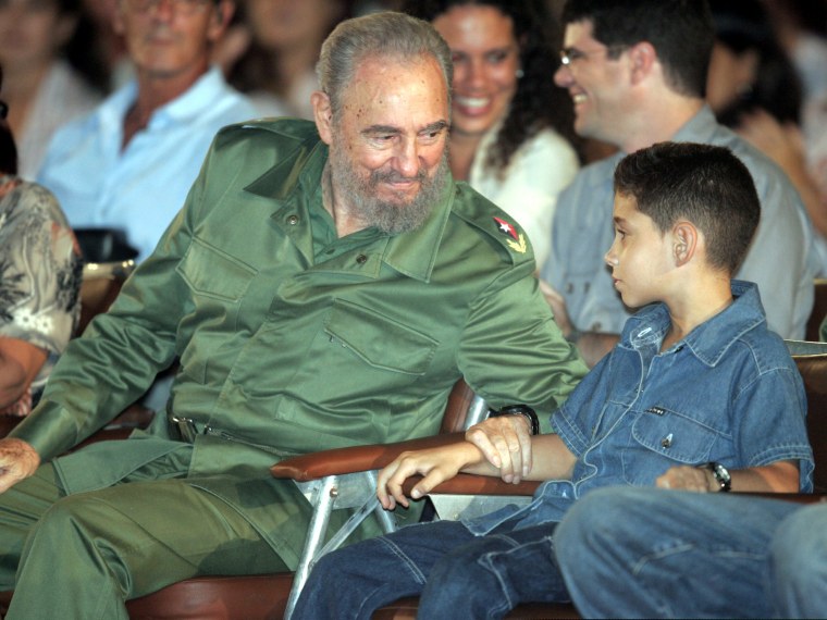 Image: Cuban President Fidel Castro (L) speaks to Cuban boy Elian Gonzalez during the a graduation ceremony..