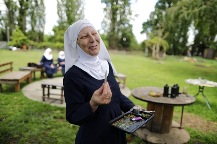 Image: California \"weed nun\" Christine Meeusen, lights a joint at Sisters of the Valley near Merced