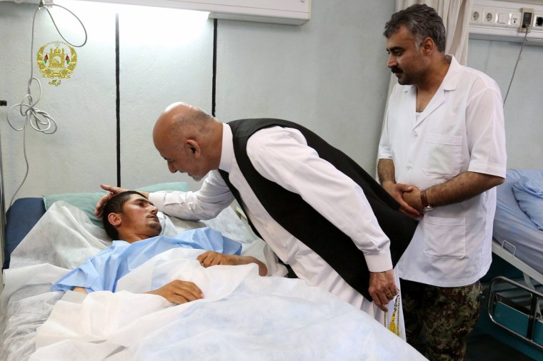 Image: Afghanistan's President Ashraf Ghani talks with a victim wounded in April 21's attack on an army headquarters during his visit in Mazar-i-Sharif, northern Afghanistan, April 22, 2017.